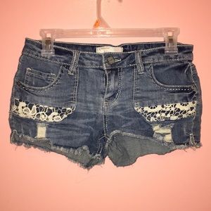 Blue denim shorts with white lace pattern